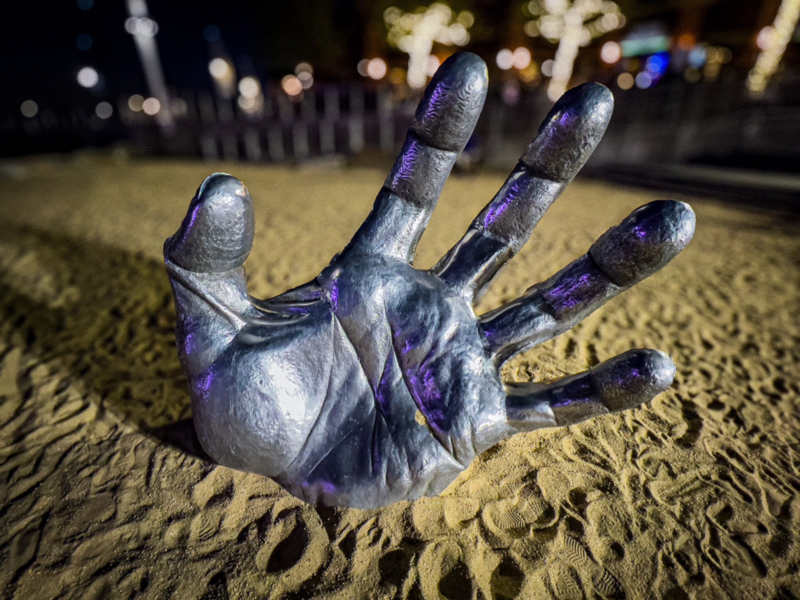 a big metal hand protruding from the ground
